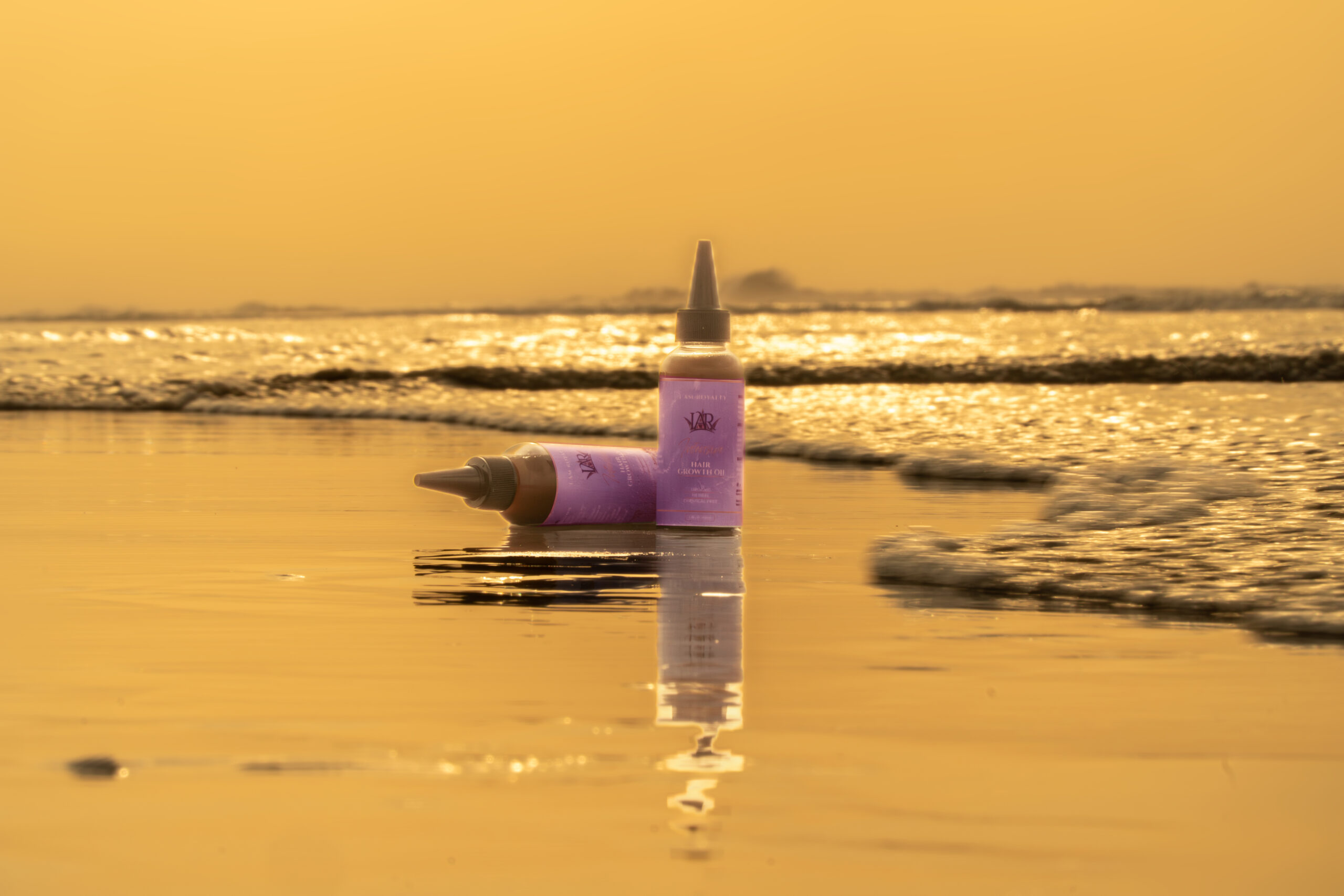 Natural ingredients and IAR hair growth oil bottle showcasing organic herbal formula